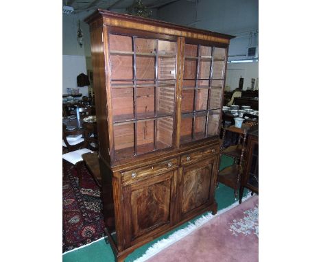 An Early 19th Century Mahogany and Brass Inlaid Bookcase, bordered with lines, the upper part with a moulded cornice, fitted 