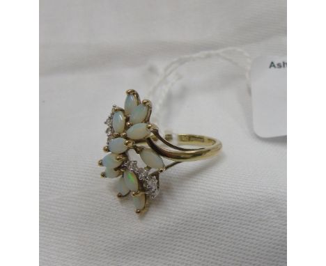 A 9 Carat Opal and Diamond Cluster Ring. 