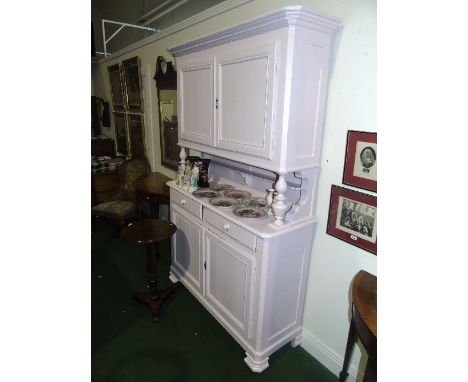 A 19th Century Continental Painted Pine Buffet, the upper section enclosed by a pair of panelled doors raised on turned colum