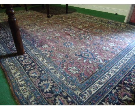 A Carpet with Central Medallion on Red & Blue Ground with alternating borders.