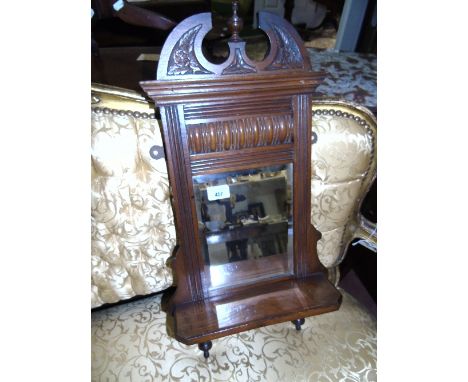 A Late 19th Century Walnut Mirror, with back wall shelf.