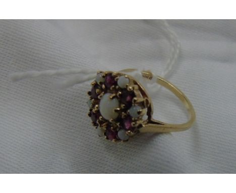 A 9 Carat Opal and Ruby Cluster Ring.