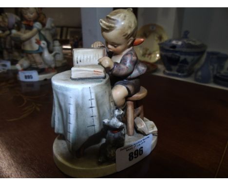 A Goebel Figure of a Young Boy Reading.