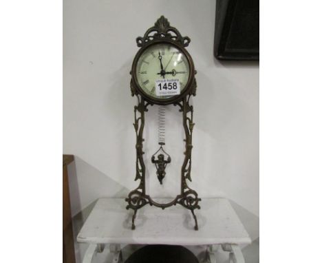 A Waterbury Clock Company brass clock with child on swing