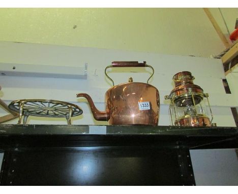 A polished copper kettle, brass trivet and copper lantern