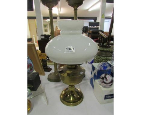 A brass oil lamp with shade but missing chimney