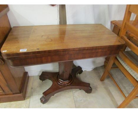 A Victorian mahogany fold over card table