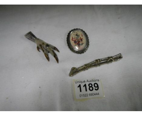 A 1950's silver brooch, A vintage rabbit foot brooch and a white metal bracelet