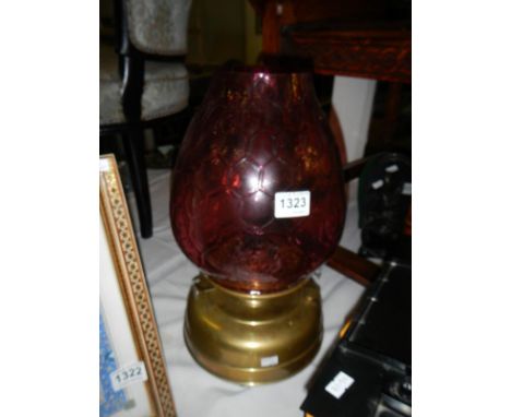 A brass oil lamp with cranberry glass shade -&nbsp;Font has been drilled for electric so won&rsquo;t hold fuel