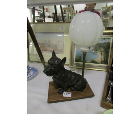 An Art Deco table lamp with a spelter terrier dog