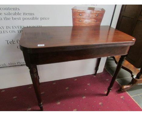 A Victorian mahogany fold over card table