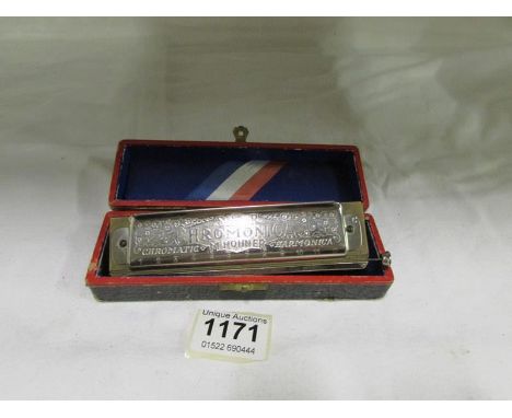 A cased Hohner harmonica