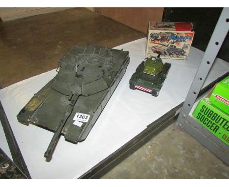 A boxed Marx clockwork sparkling tank and a large rubber model tank