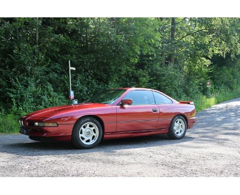 The 1991 BMW 850i, finished in metallic bordeaux red, is a first-owner vehicle with a complete service history from Switzerla