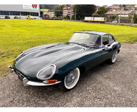 This 1968 Jaguar E-Type 4.2 is a classic car in a striking green color. It has an odometer reading of 74,181 km, although the