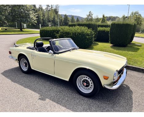 The 1971 Triumph TR6, in a vibrant yellow, offers a striking example of classic British sports car design. Registered as a Sw