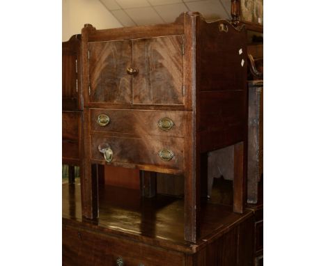 A George III mahogany night commode, with tray top above cupboard and sliding base with compartment, 76cm high, 