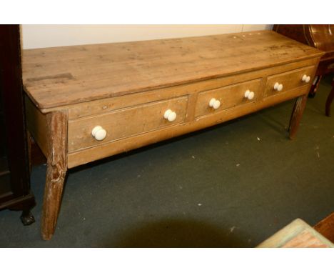 A Victorian pine dresser base, each drawer with white ceramic handles, 217cm long 