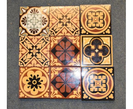 A box containing a quantity of encaustic tiles, various designs mostly Gothic Revival, most with marks for Godwin Lugwardine,