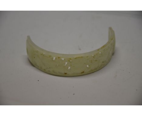 A Chinese white jade hair ornament, of convex shape with pierced floral carving and two holes to each end, 8cm long 