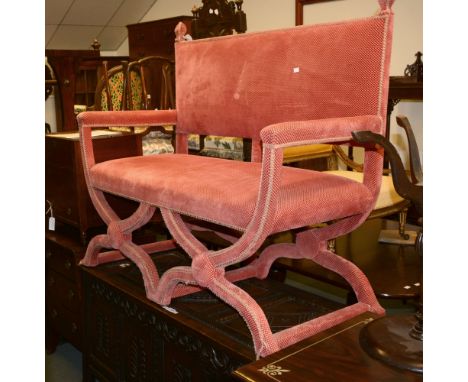 A pale red upholstered two-seat sofa in Jacobean manner, on double X-frame supports, 120cm high, 129cm long, 60cm deep 