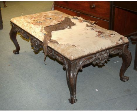 A Victorian carved mahogany centre stool with distressed tapestry upholstered seat, 43cm high, the top 60 x 120 