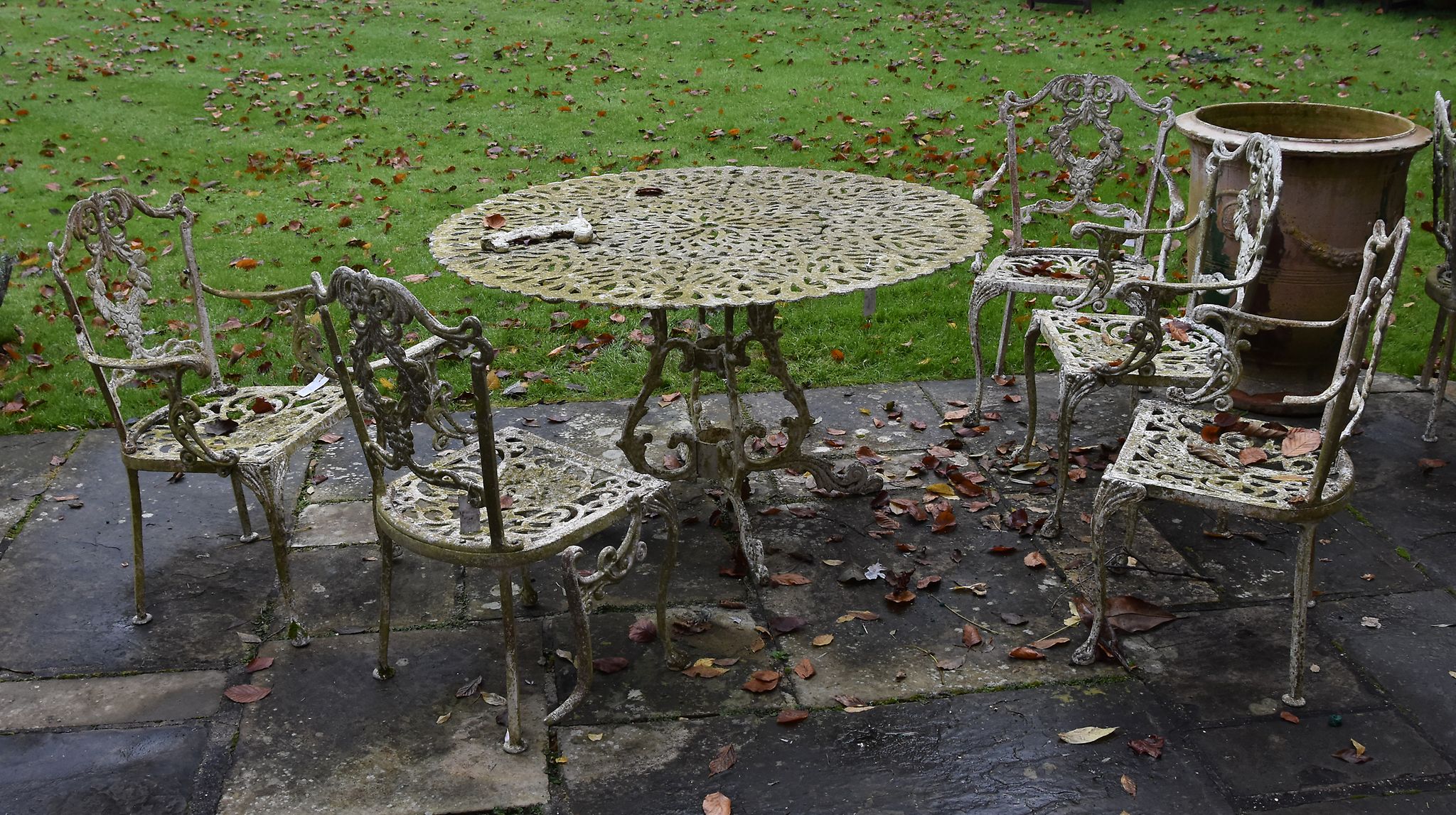 A painted metal garden table and six chairs en-suite, 20th century This
