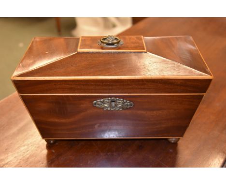 A George IV mahogany and sycamore strung tea caddy, circa 1825, of sarcophagus form, on brass ball feet, 17cm high, 28cm wide
