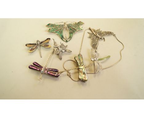 A large 925 and enamel dragonfly brooch; together with four other dragonfly brooches; and two fairy items. [7]