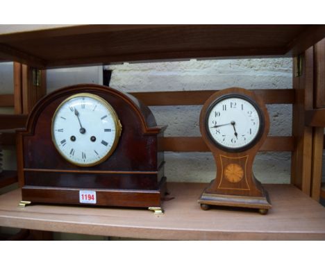 A circa 1920 mahogany mantel clock, 28cm wide; together with an Edwardian mahogany and inlaid balloon timepiece, 21.5cm high.