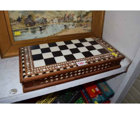 An eastern sandalwood and ebony chess set, in folding inlaid box. 