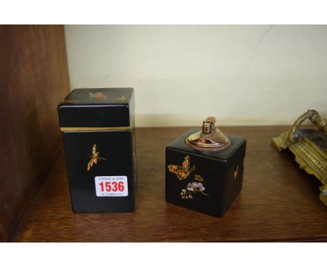 A Carltonware jar and cover and matching table lighter, decorated with butterflies and insects against a black ground, the ja