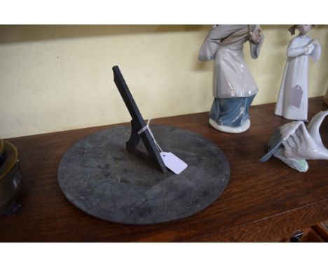 An old copper sundial, 24.5cm diameter. 