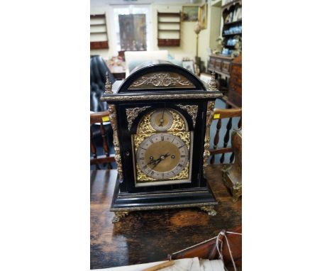 A late 19th century, George III style, ebonized and brass mounted mantel clock, with twin fusee movement, 43cm high. 
