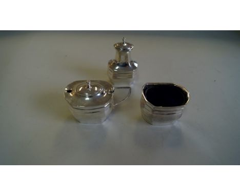 A silver three piece cruet set, by E S & Co., Sheffield 1951, comprising a mustard, a salt, with blue glass liner; and a pepp