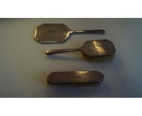 An engine turned silver three piece brush set, by Adie Brothers Ltd, Birmingham 1956, comprising two hair brushes and hand mi