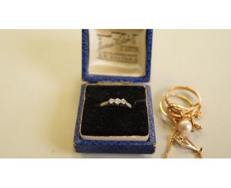 An 18ct gold and platinum diamond trilogy ring; together with an 18ct gold fine chain; and five other items of jewellery. [7]