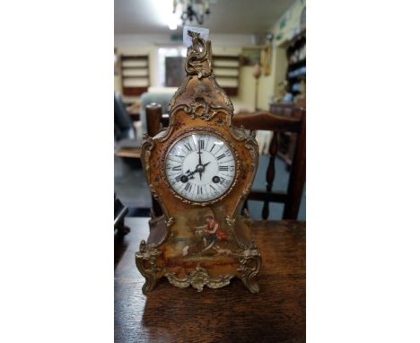 A late 19th century, Louis XV style mantel clock, painted with a figure beside a lake on a gilt ground, the whole with cast b