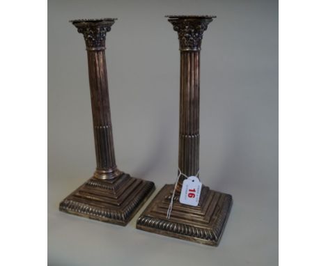 A pair of Victorian silver Corinthian column candlesticks, by Carrington & Co, Sheffield 1897, on square stepped bases, 30.5c