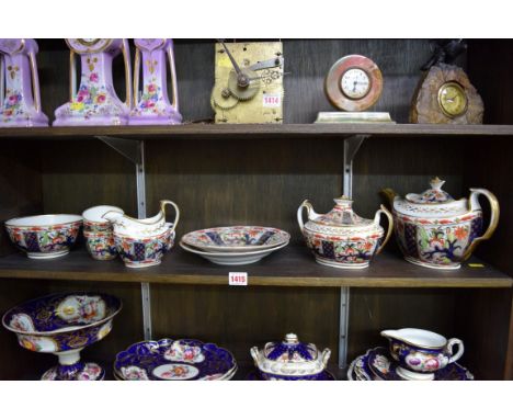 A Regency English porcelain part tea service, painted with an Imari design.  Condition Report: All pieces have chips or hairl