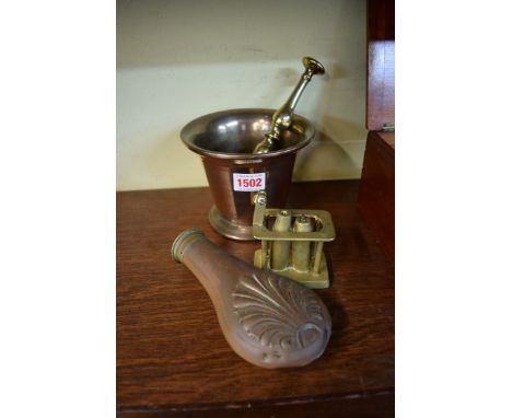 A bell metal mortar; together with a brass pestle, a copper powder flask; and a trench art cigar lighter.  