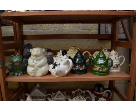 A quantity of novelty teapots and similar, to include examples by Wade.