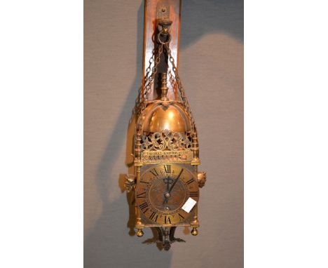 A modern reproduction of a 17th century brass lantern timepiece, the case with applied maskheads, bearing inscription   after