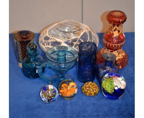 An assortment of mostly coloured glass to include a pale ruby flashed night carafe and goblet, paperweights, etc.   Provenanc