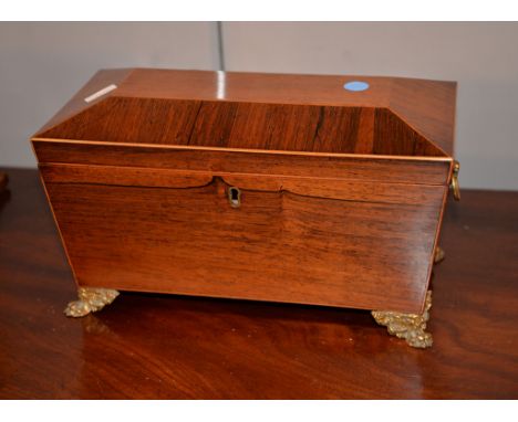 Ω A Regency rosewood and satinwood banded tea caddy, of sarcophagus form, with gilt lion paw feet, 32cm wide Please note , th