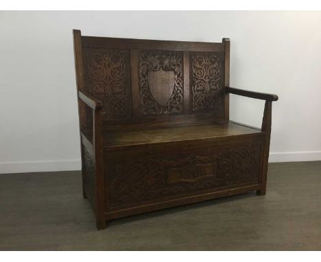 EDWARDIAN OAK CELTIC REVIVAL HALL SETTLE, CIRCA 1902 the panelled back carved with Celtic knots and mythical beasts, with vac