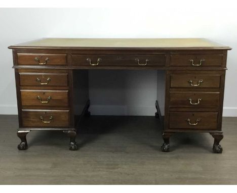 REPRODUCTION MAHOGANY KNEE HOLE DESK, 20TH CENTURY  the rectangular top inset with a mustard skiver, above one long flanked b