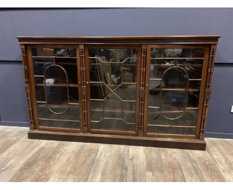 VICTORIAN MAHOGANY TRIPLE BOOKCASE, LATE 19TH CENTURY  with moulded cornice over a blind fret freize, the astragal glazed doo