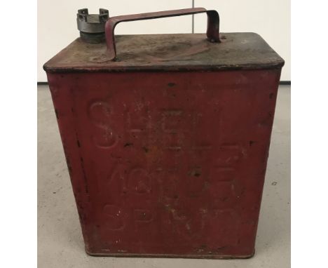 A vintage red Shell petrol can. Logo to top.Shell wording to both sides and brass cap.