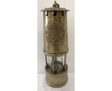 A vintage brass miners safety lamp "The Protector", with name plate.From the Lamp &amp; Lighting Co Ltd, Eccles, Manchester. 